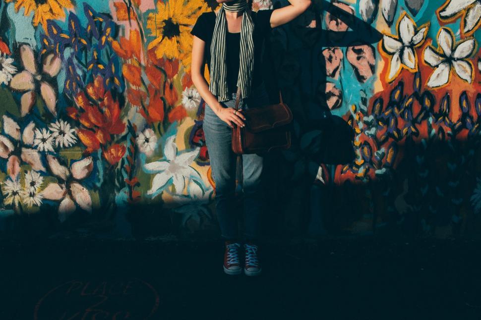 Free Image of Two People Standing in Front of a Colorful Wall 