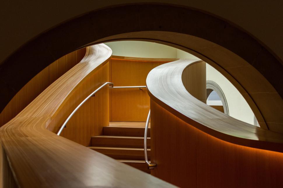 Free Image of A Glimpse of Staircase Through Circular Window 