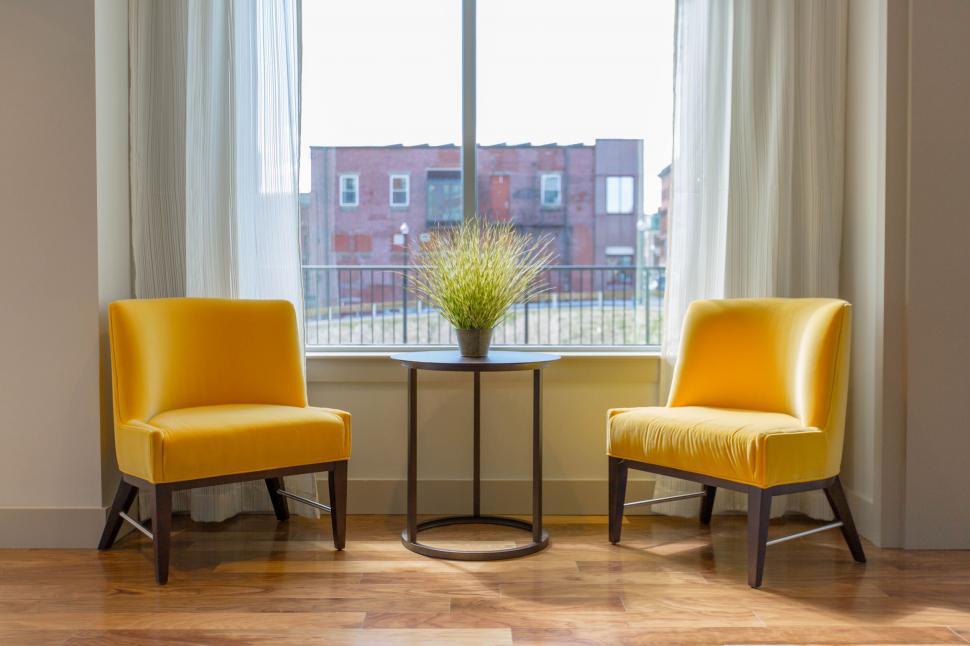 Free Image of Two Yellow Chairs in Front of Window 
