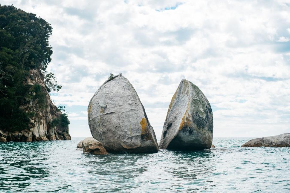 Free Image of Two Large Rocks Emerging From Water 