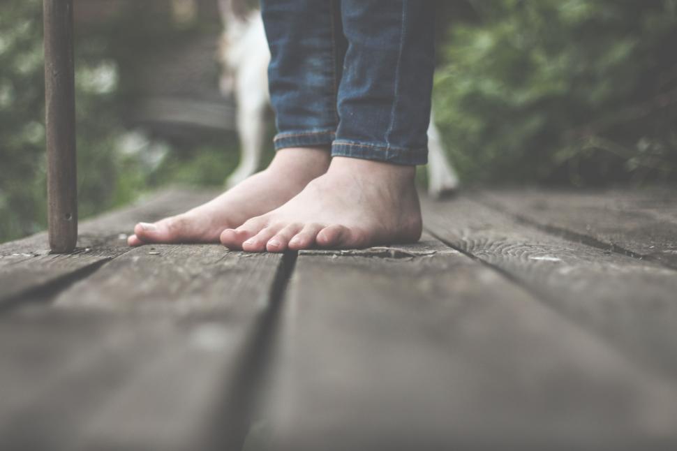 Free Image of Person Standing on Wooden Deck With Bare Feet 