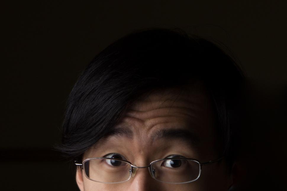 Free Image of Man With Glasses and Tie in Dark Room 