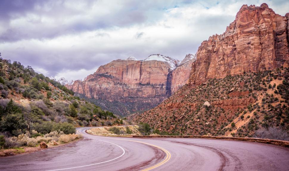Free Image of Curved Road With Mountains in Background 