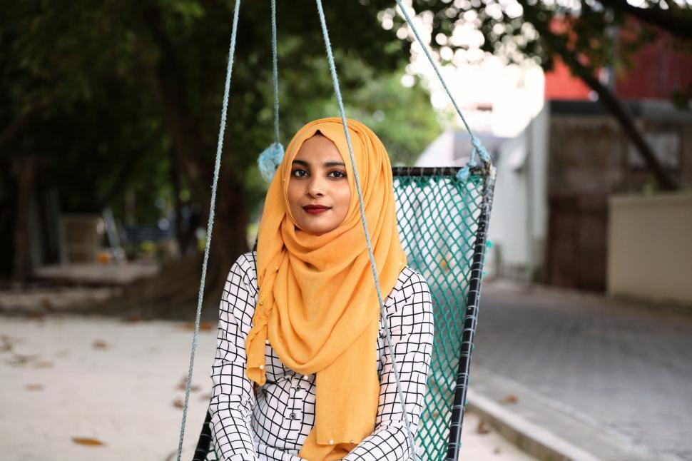 Free Image of Woman in a Hijab Sitting on a Swing 