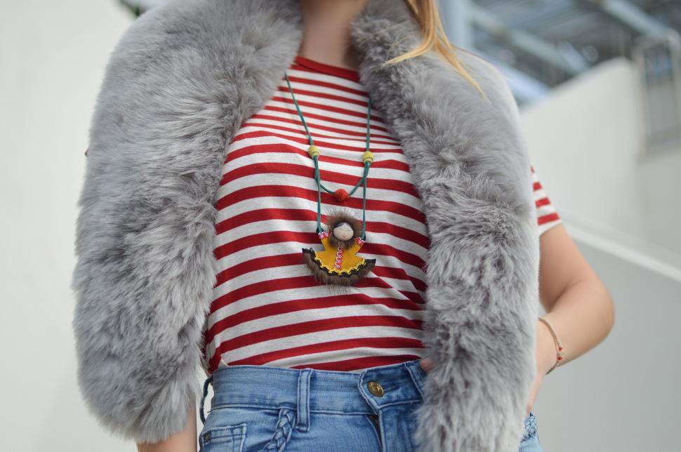 Free Image of Woman in Red and White Striped Shirt and Gray Fur Vest 