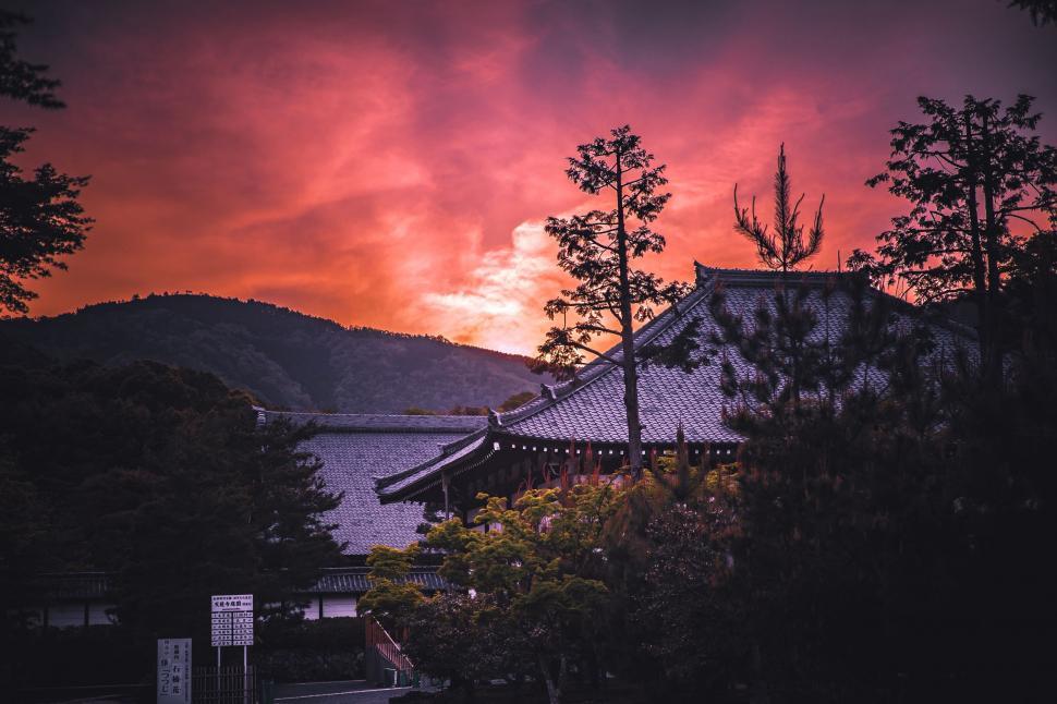 Free Image of Sunset View of Building and Mountain 