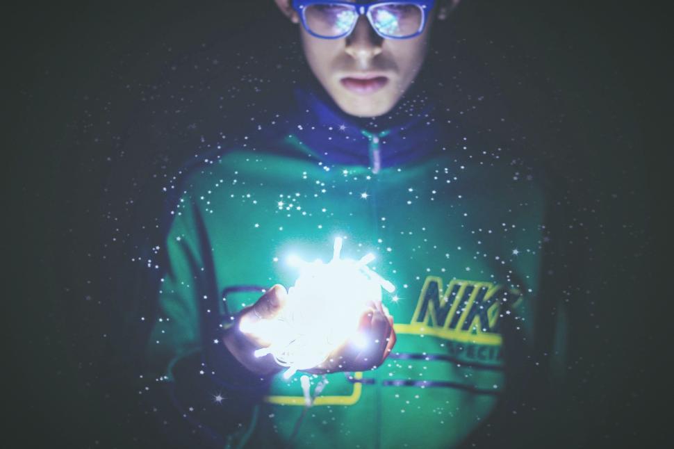 Free Image of Man Wearing Glasses Holding Glowing Object 