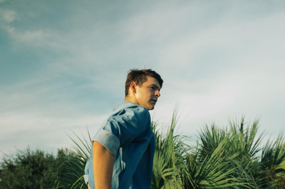 Free Image of Man in Blue Shirt Standing in Field 