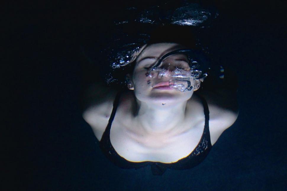 Free Image of Woman in Black Tank Top Floating in Water 
