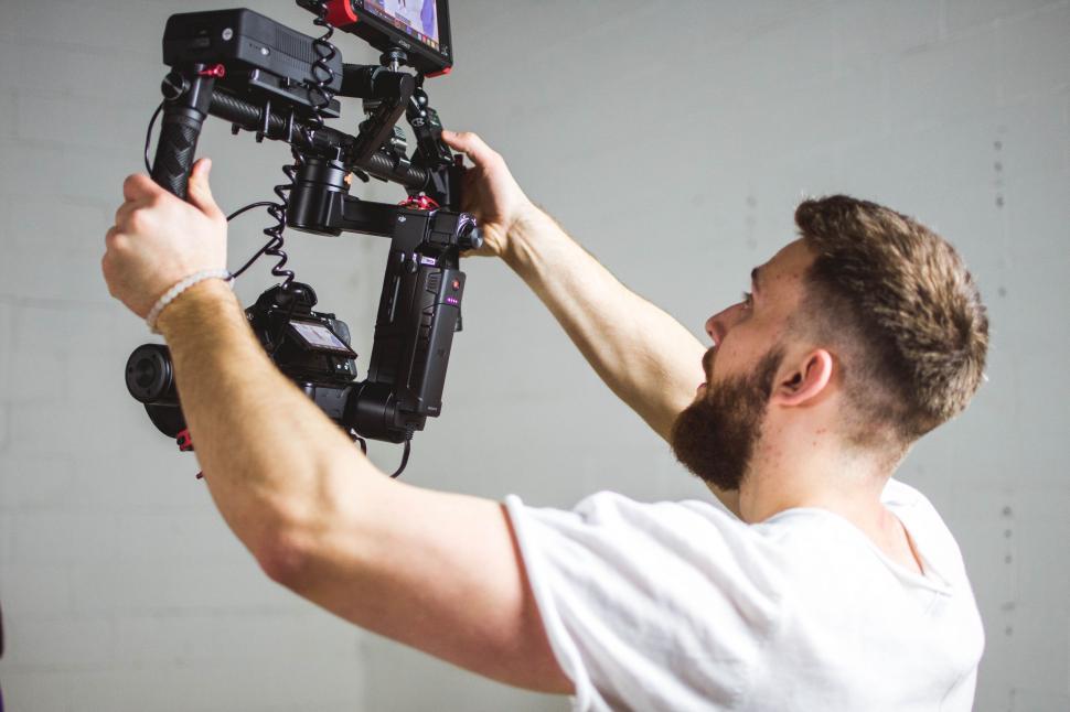Free Image of Man Holding Video Camera Up to His Face 
