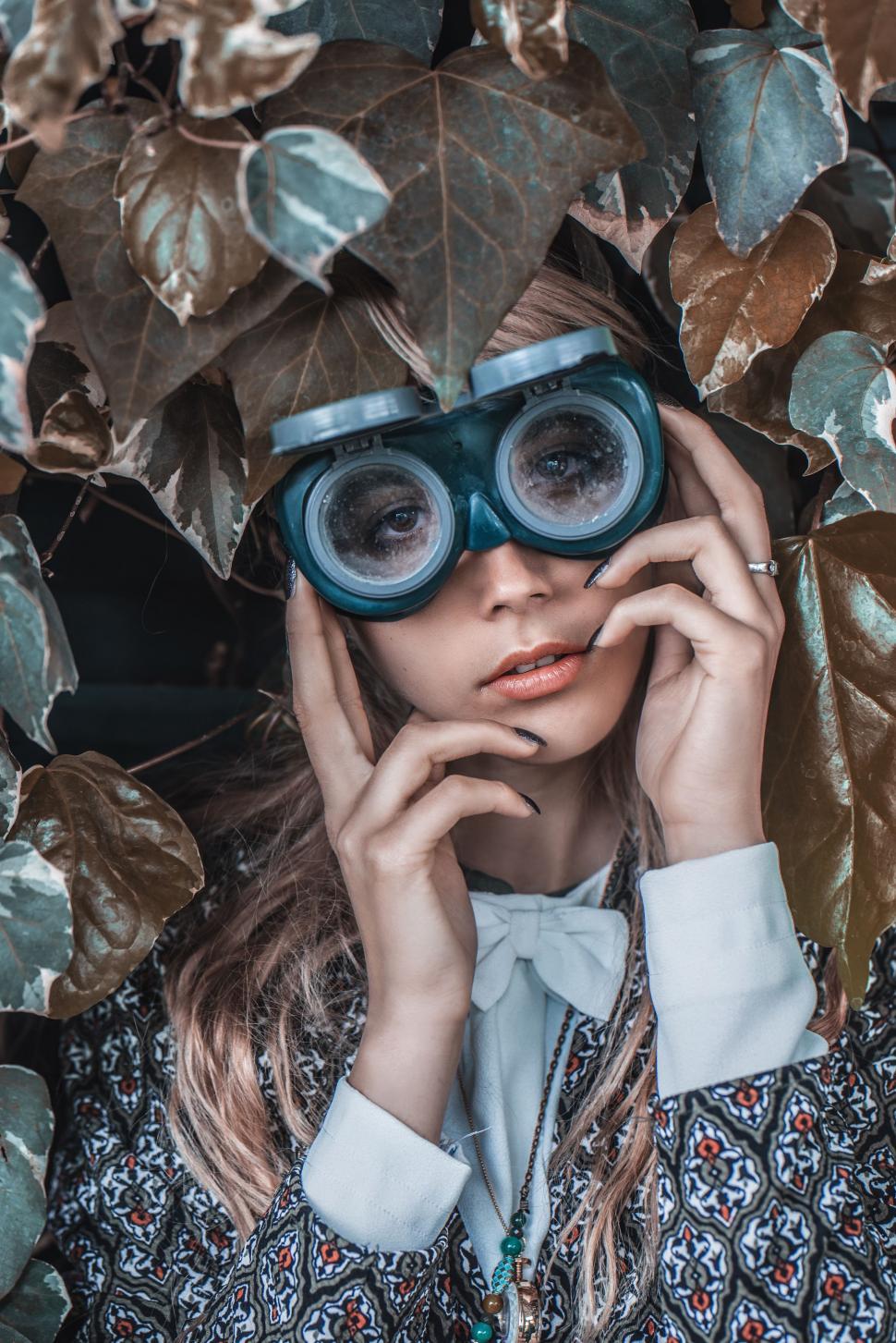 Free Image of Woman Wearing Goggles and Shirt With Leaves 