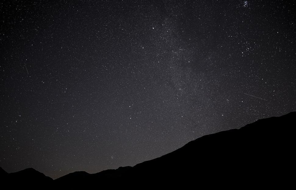 Free Image of Night Sky With Stars Above a Mountain 