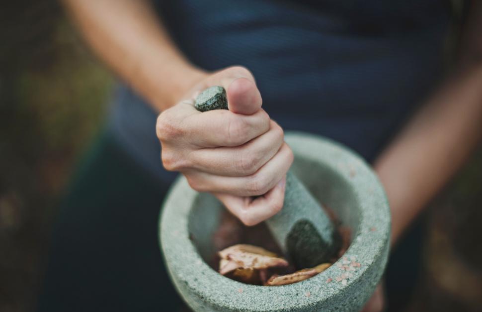 Free Image of Person Holding Small Pot With Rocks 