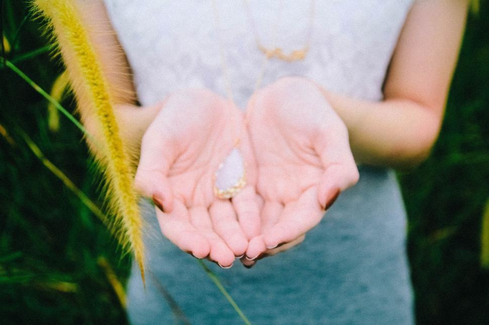 Free Image of Woman Holding Out Her Hands in a Field 