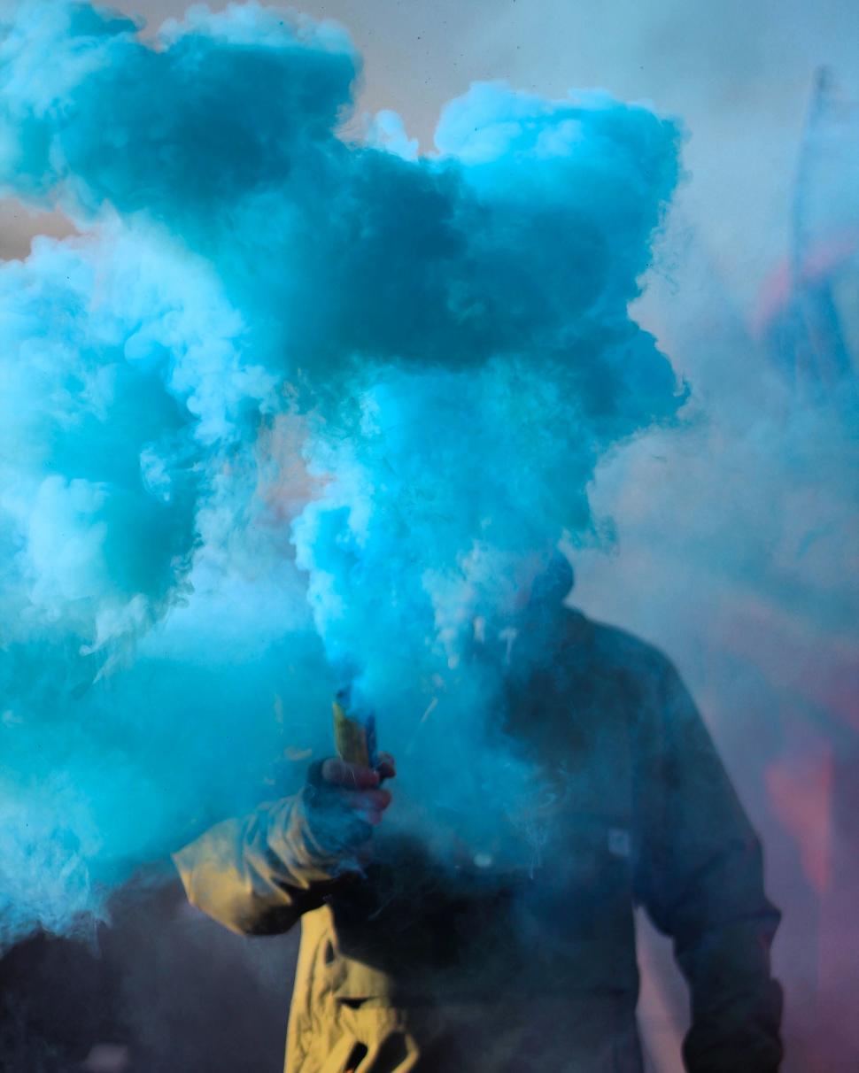Free Image of Man Exhaling Blue Smoke 