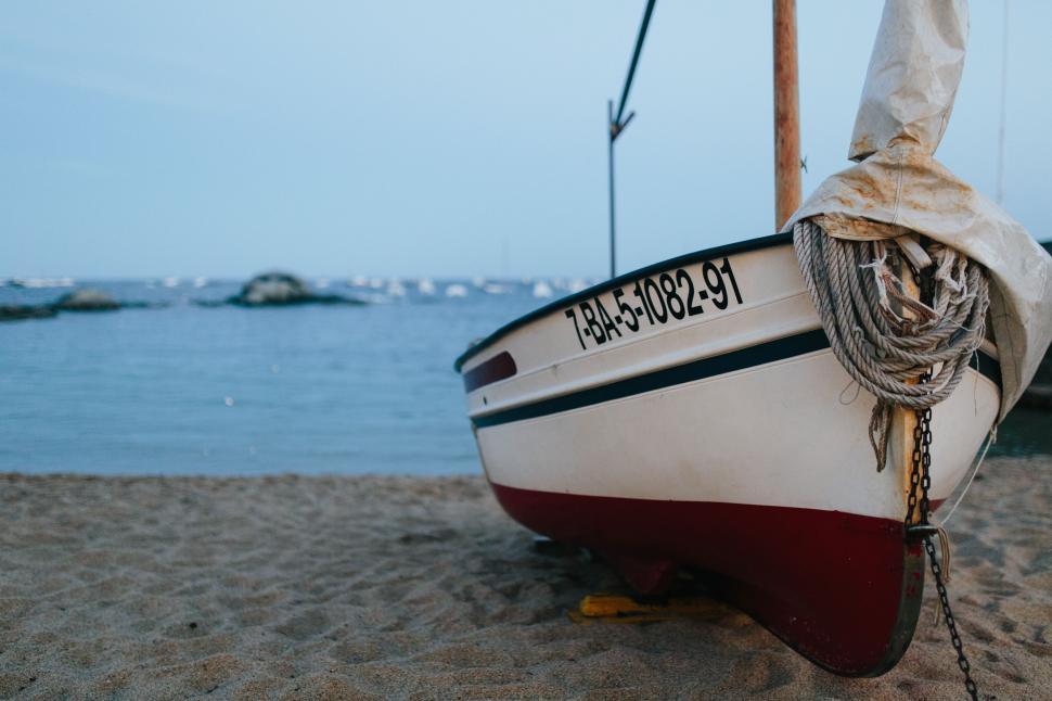 Free Image of Boat Resting on Sandy Beach 