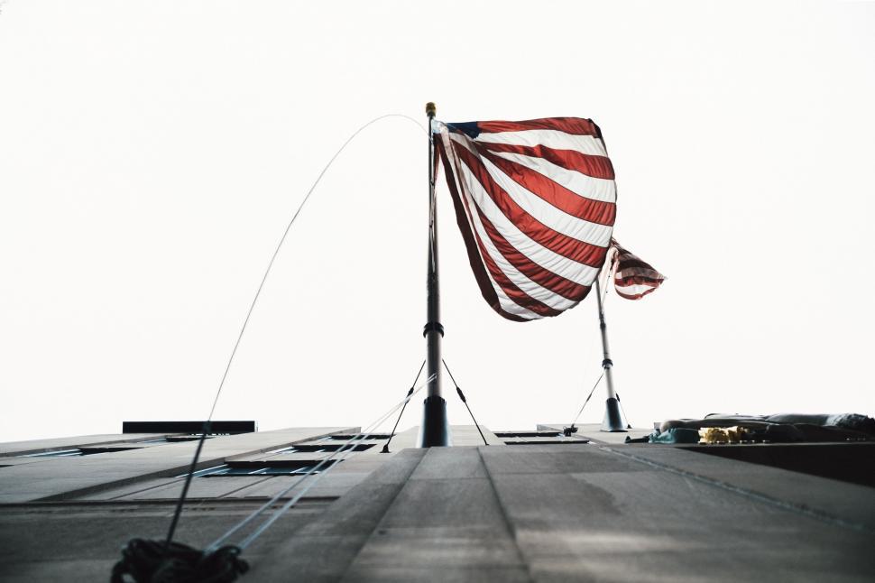 Free Image of Large American Flag Atop Building 