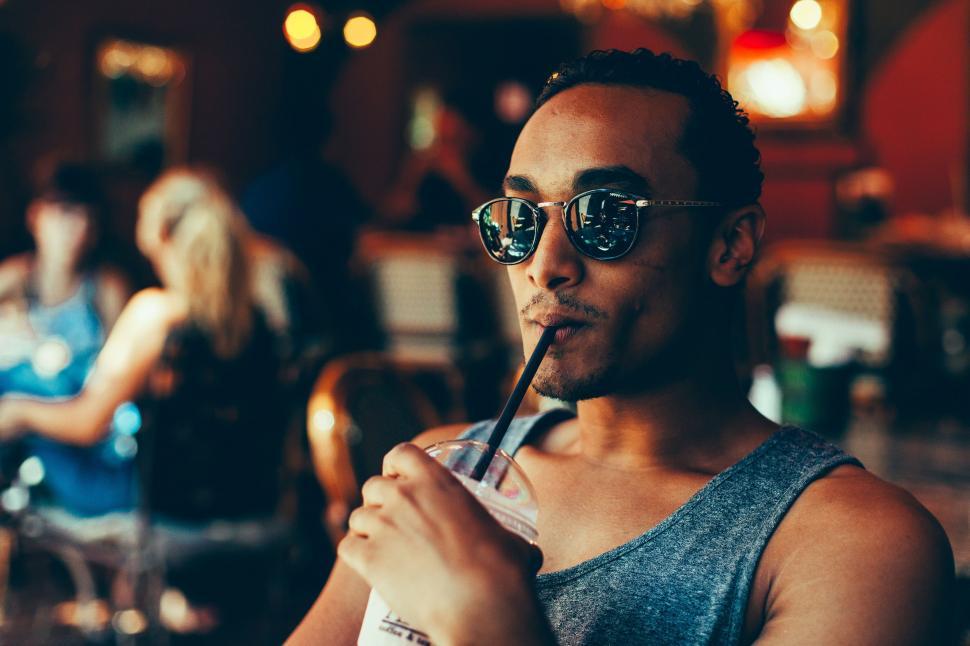Free Image of Man Drinking Drink With Straw 