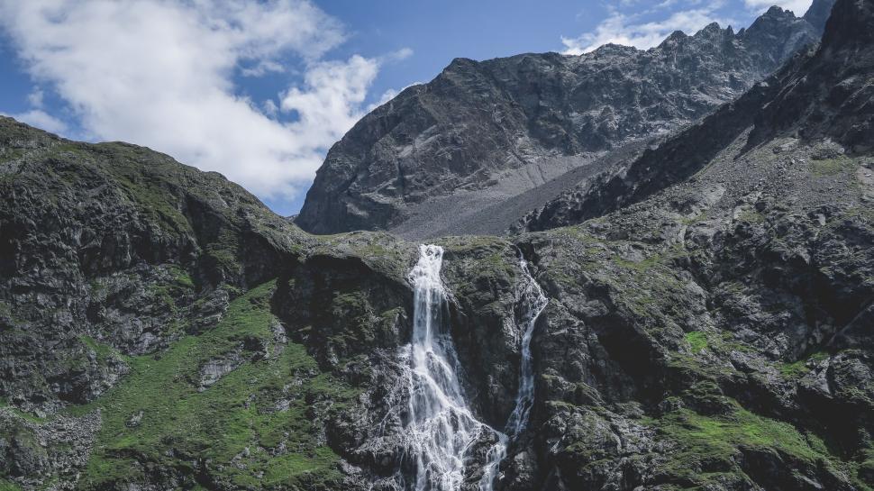 Free Image of Majestic Waterfall in a Mountain Range 