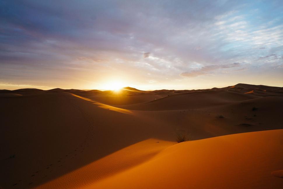 Free Image of The Sun Sets Over a Desert Landscape 