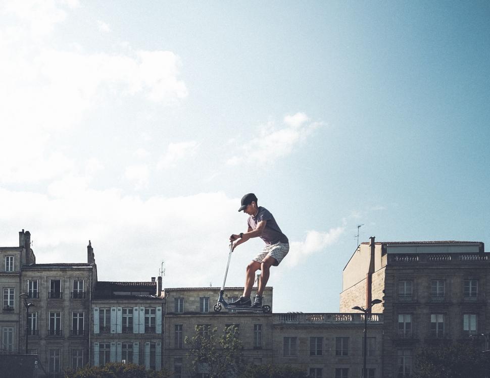 Free Image of Man Riding Skateboard Up Side of Building 