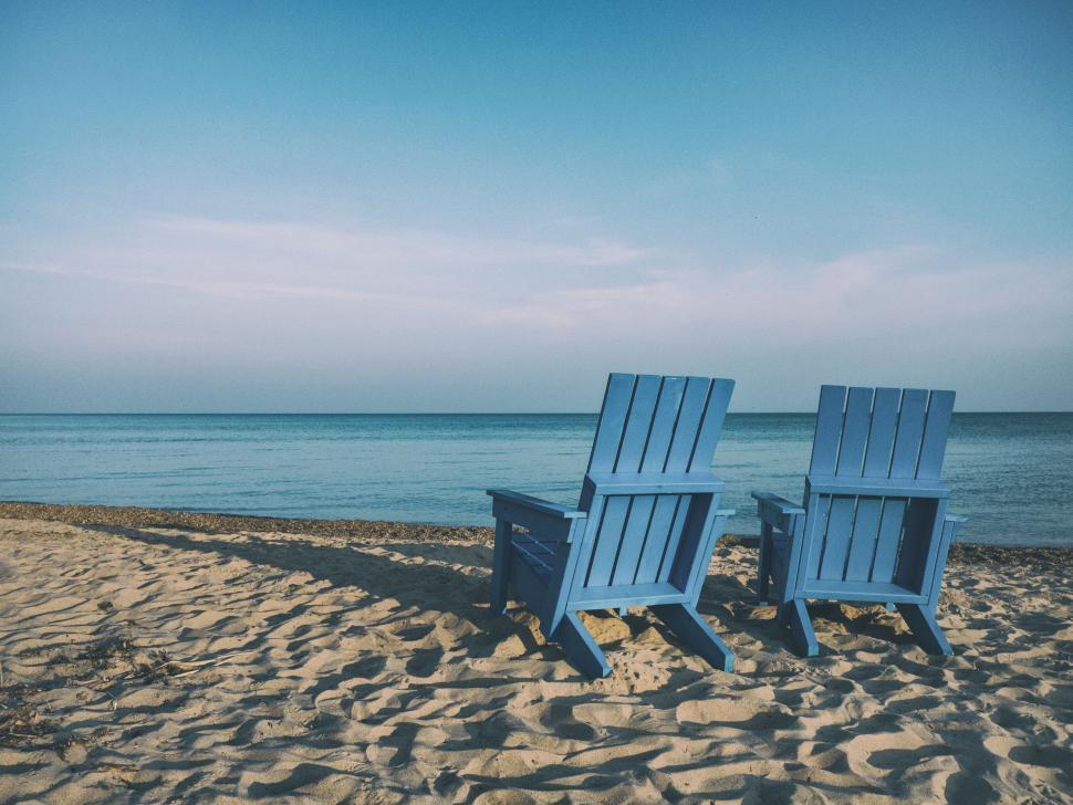 Free Image of Two Blue Chairs on Sandy Beach 