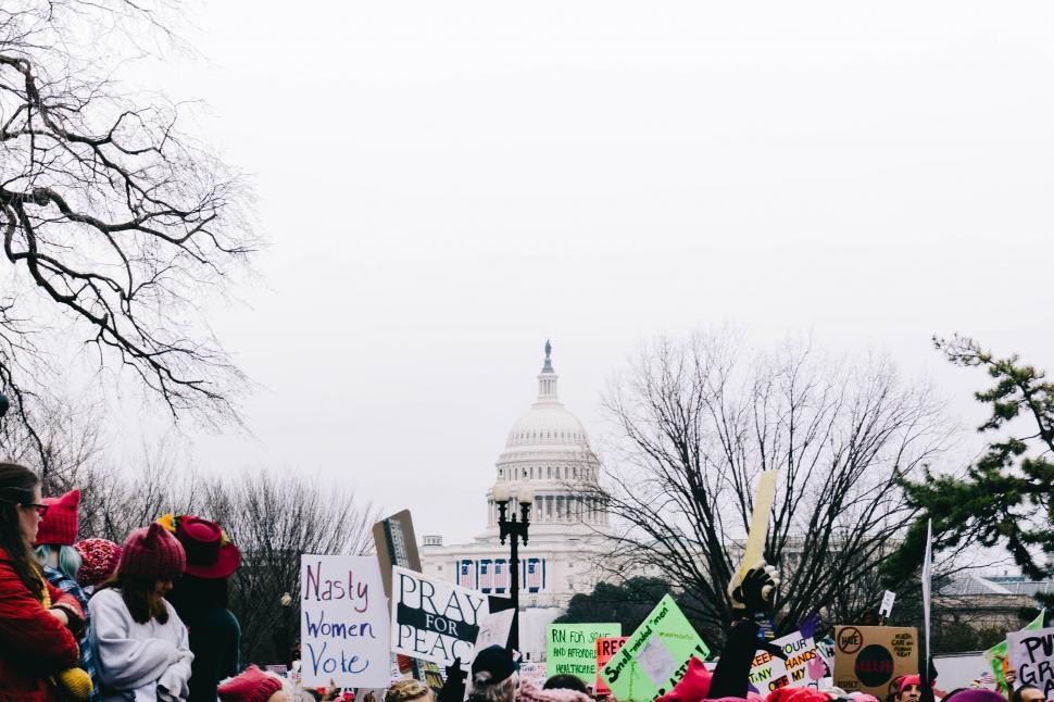 Free Image of Group of People Holding Signs in Front of the Capitol Building 