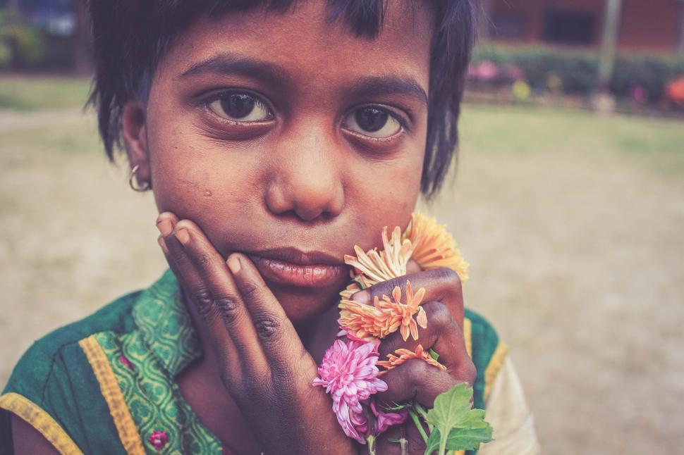 Free Image of Young Girl Holding Bunch of Flowers 