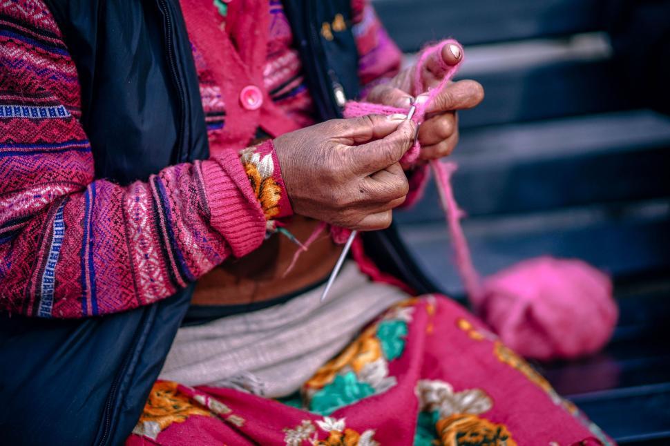 Free Image of Woman Knitting in Colorful Dress 