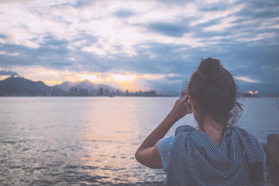 Free Image of Woman Gazing at Horizon Over Water 