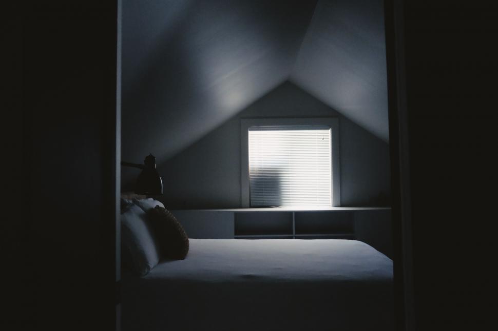 Free Image of Dark Room With Bed and Window 