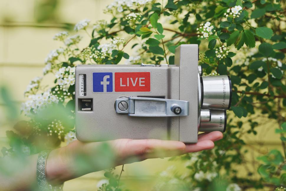 Free Image of Hand Holding Camera With Facebook Live Sticker 