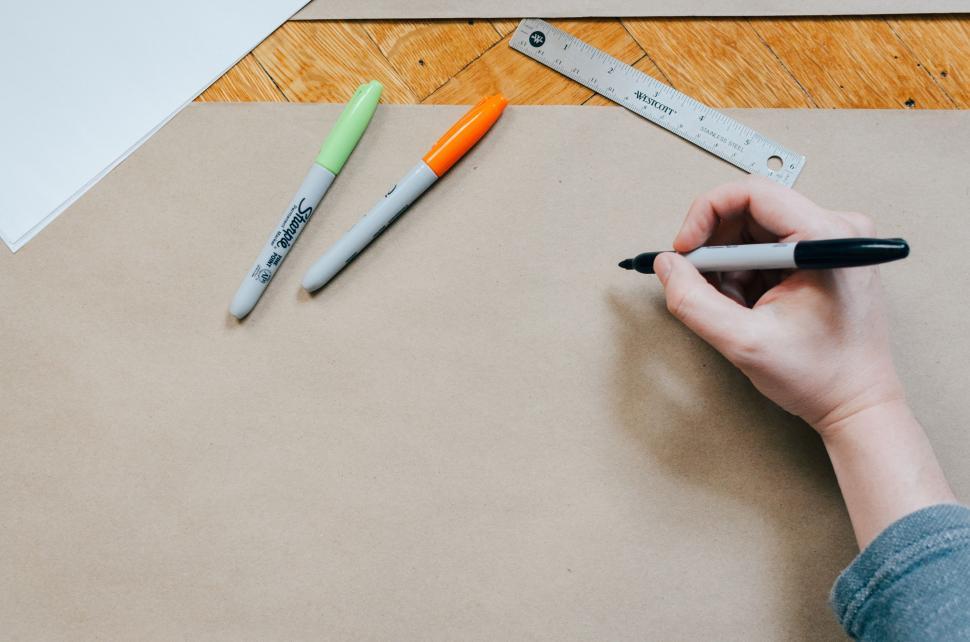 Free Image of Person Drawing on Piece of Paper 