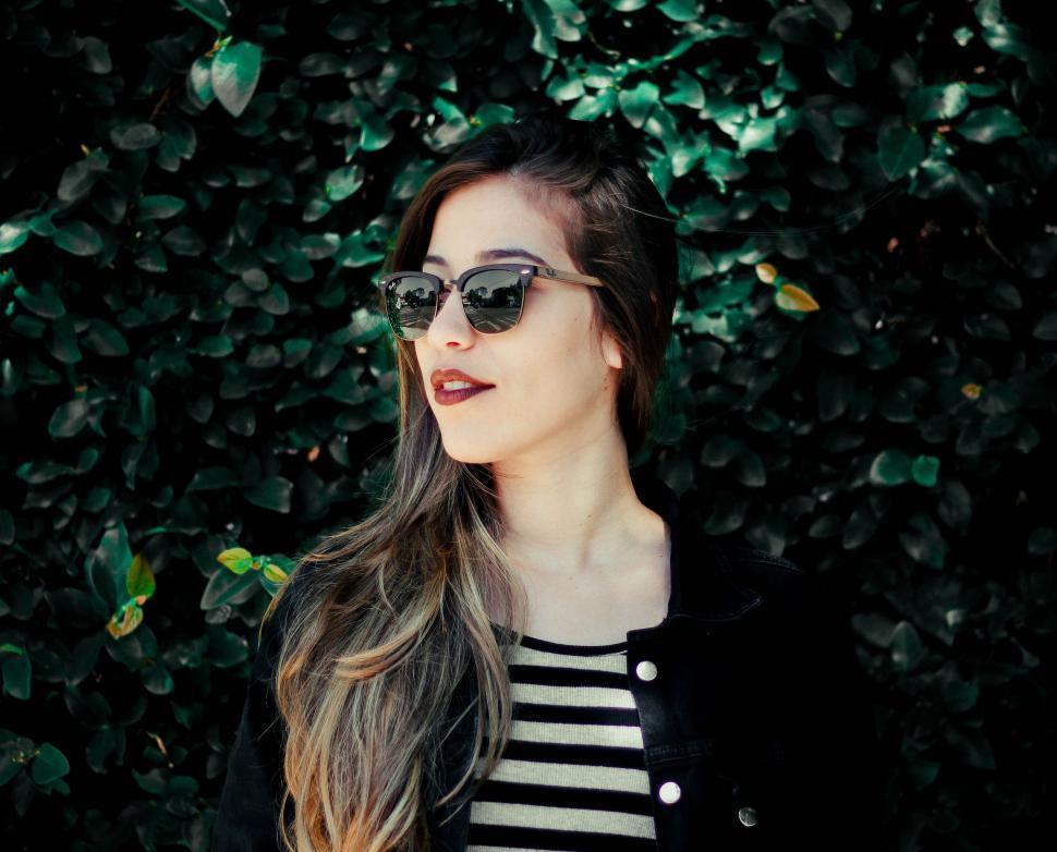 Free Image of Woman Wearing Sunglasses and Striped Shirt 