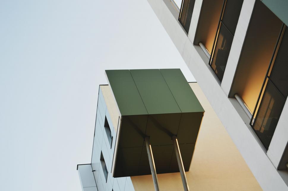 Free Image of Tall Building With Green Roof and Windows 