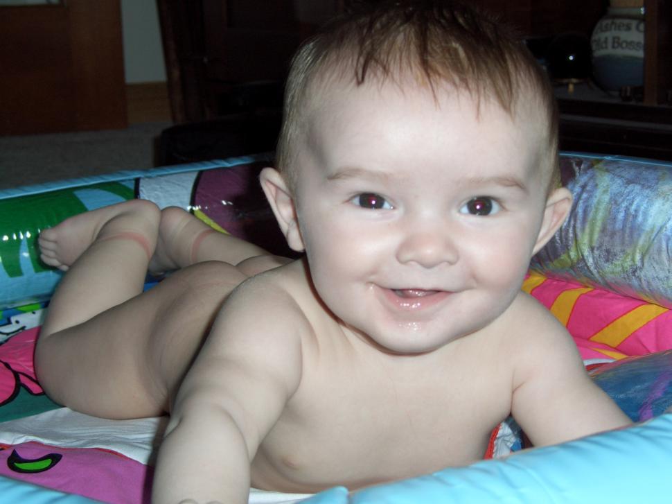 Free Image of Baby Smiling in Baby Bed 