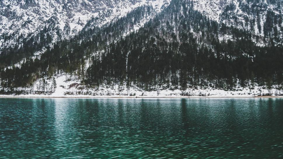 Free Image of Snow-Covered Mountain Beside Body of Water 
