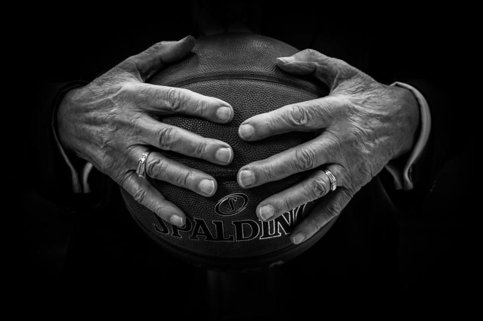Free Image of Two Hands Holding a Basketball 