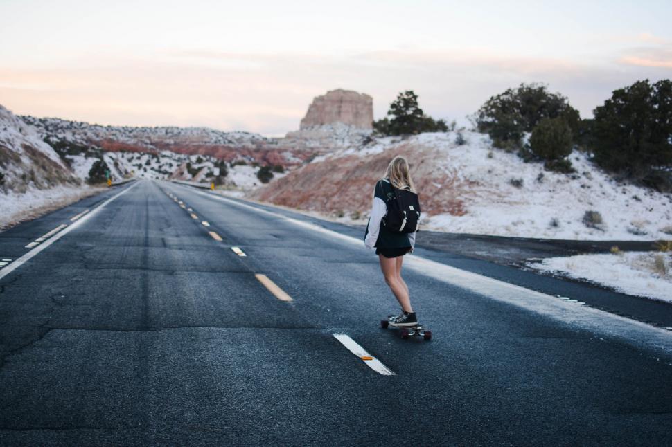 Free Image of Person Riding Skateboard Down Road 