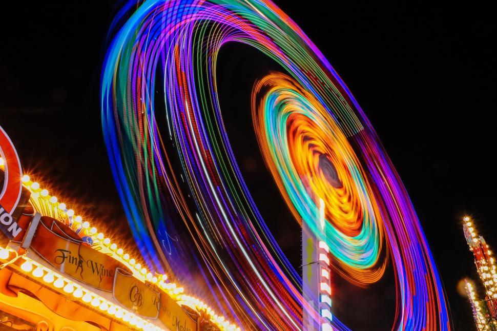 Free Image of Vibrant Carnival Ride Illuminated by Colorful Lights at Night 