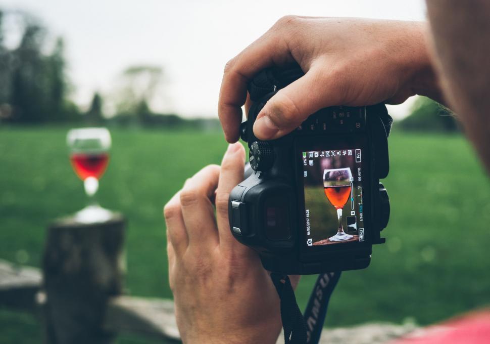Free Image of Person Holding Camera Taking Picture of Two Wine Glasses 