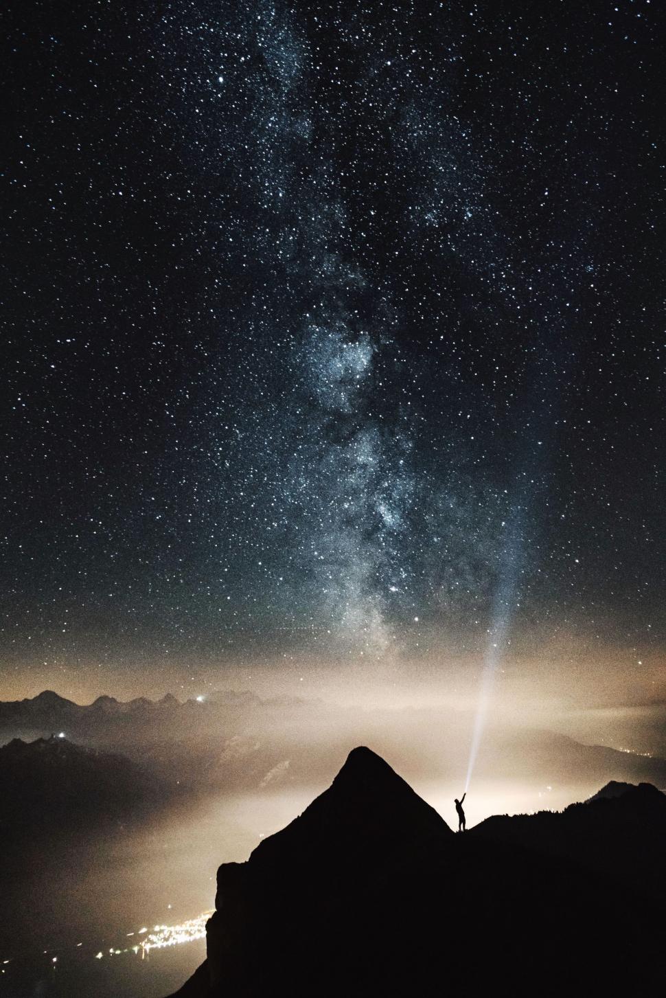 Free Image of Person Standing on Top of Mountain Under Night Sky 
