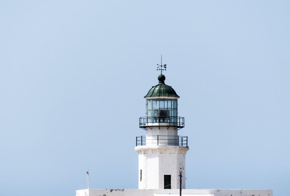 Free Image of White Lighthouse With Black Roof on Clear Day 
