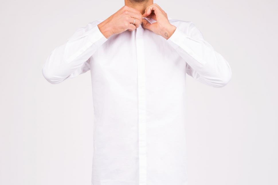 Free Image of Man in White Shirt Posing for Picture 