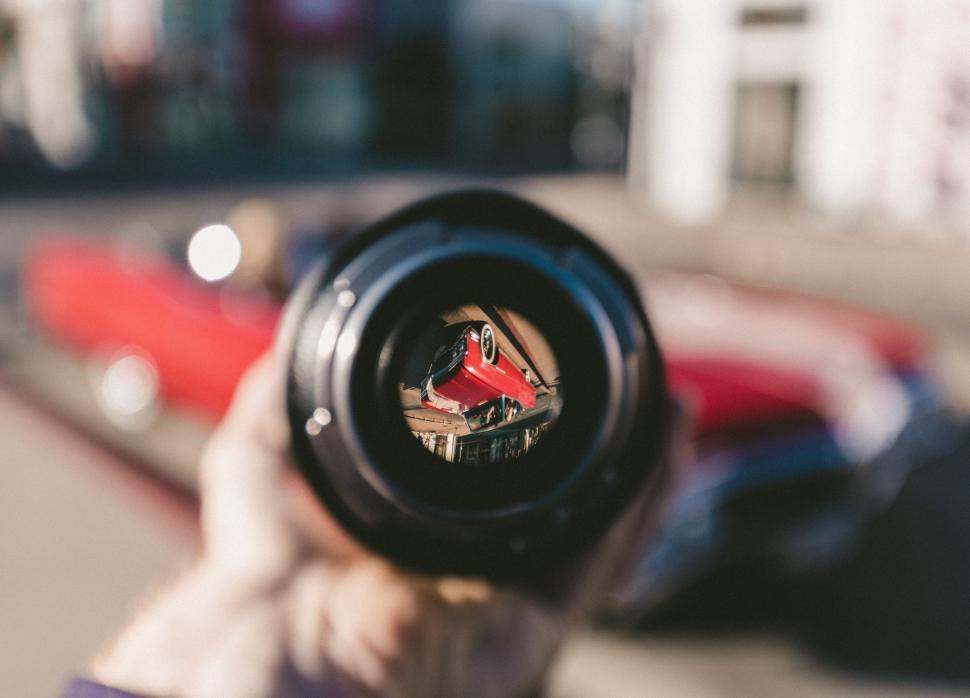 Free Image of Person Capturing Red Car Using Lens 