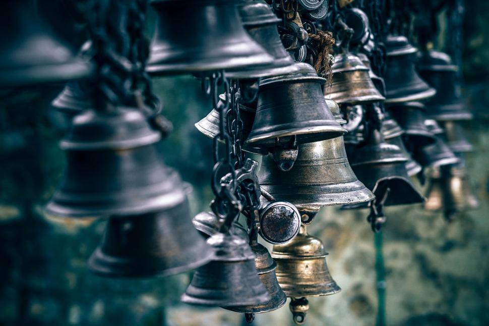 Free Image of Array of Bells Hanging From a Wall 