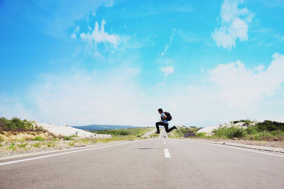 Free Image of Person Jumping in the Air on Road 