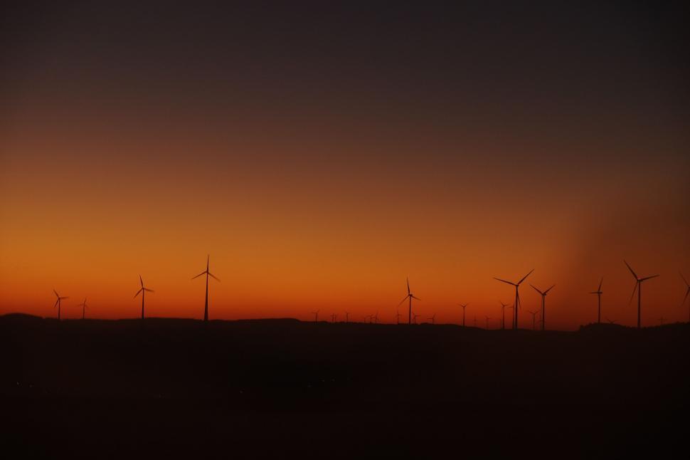 Free Image of Group of Windmills in Field at Sunset 