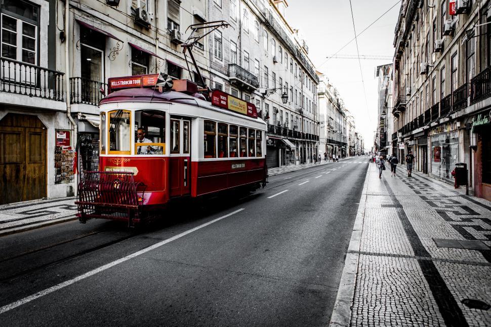 Free Image of Red and White Trolley on a City Street 