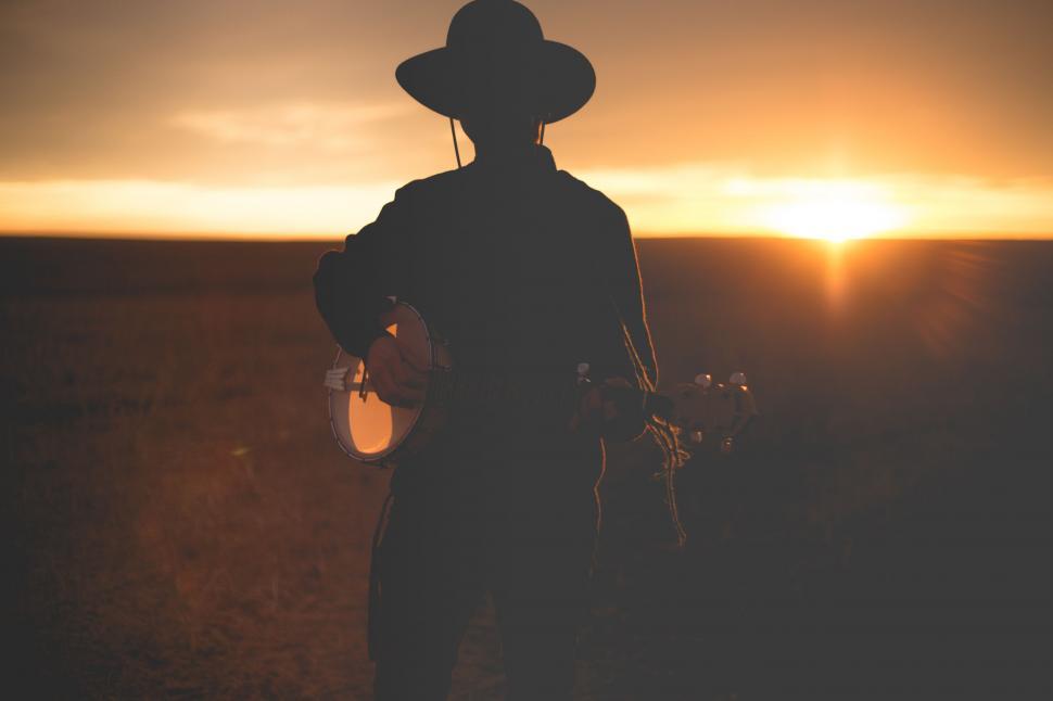 Free Image of Silhouette of Person Wearing Cowboy Hat 